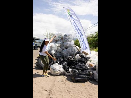 Lauri-Ann Samuels, executive director, National Baking Company Foundation, shows off their trash collection haul from her team’s efforts on International Coastal Cleanup Day 2025 on September 20.