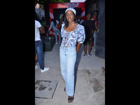 Credit: Antoine Lodge Fine jewellery designer Symoné Currie matches her light wash denim with a tie front floral crop top and matching head scarf.