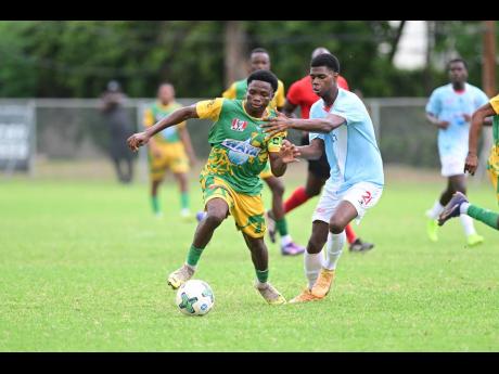 Credit: Gladstone Taylor Gladstone Taylor/Multimedia Photo Editor
Excelsior’s Kimarly Brown evades the tackle of St George’s College’s Kevaughn Brown during their ISSA/WATA daCosta Cup game at Winchester Park yesterday.