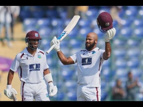 West Indies’ John Campbell (right) celebrates after scoring a century as batting partner West Indies’ Shai Hope watches on the fourth day of the second Test match against India at the Arun Jaitley Stadium in New Delhi, India, on Monday.