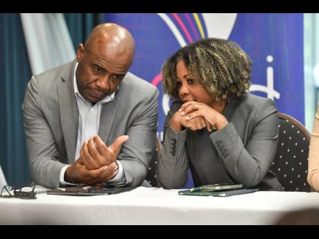 Dr Adrian Stokes (left), chairman of the Education Transformation Oversight Committee, and Education Minister Dr Dana Morris Dixon in conversation at an ETOC press conference yesterday.