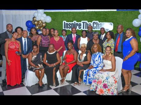  Members of the Kiwanis Club of West St Andrew, along with executive members of Kiwanis International, following the installation ceremony for the club’s new administration, held at the Terra Nova All-Suite Hotel. The new administration is headed by Maur