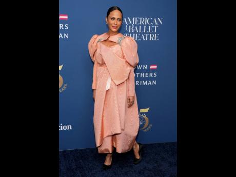 Credit: AP Nicole Ari Parker is on point, pairing her peach satin dress with Christian Louboutin’s Cassia Nodo pump in black crepe satin, a stiletto-inspired pointe shoe.