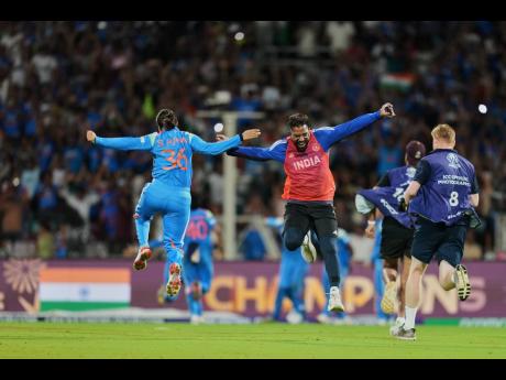 Credit: AP India’s Sneh Rana (left) and a team support staff celebrate after winning the ICC Women’s Cricket World Cup final match between India and South Africa in Navi Mumbai, India, yesterday.