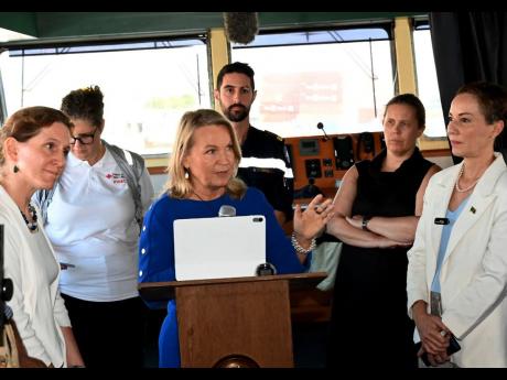 Credit: Contributed EU Ambassador Dr Erja Askola delivers remarks during Monday’s handing over of emergency supplies following Hurricane Melissa. Foreign Affairs Minister Kamina Johnson Smith (right) and European partners look on.