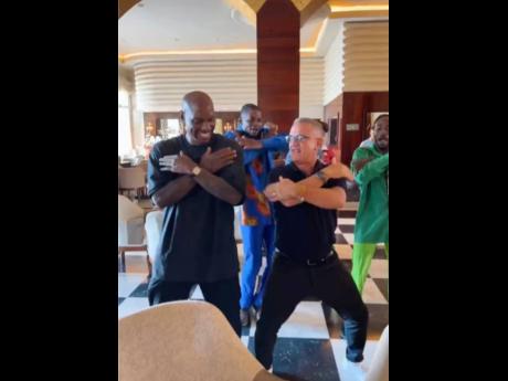 Actor Tyrese Gibson (left) dances with the Iberostar team, which included entertainment manager at JOIA Rose Hall by Iberostar, Deivy Noel (right), and the entertainment dance group in the background.