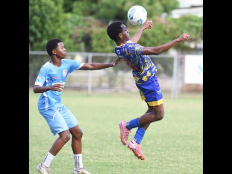 Credit: Ian Allen Ian Allen/Photographer
St Elizabeth Technical High School’s (STETHS’) Deandre Barnett (right) controls a ball on his chest ahead of St George’s College’s Malick Garrick during a practice match at Winchester Park yesterday. STETHS ran out 4-0 winne