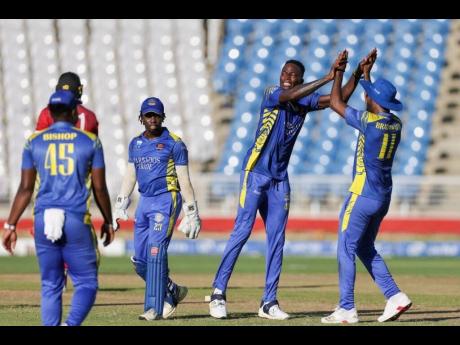 Photo by CWI Media 
Dominic Drakes (second right) celebrates one of his four wickets against the Trinidad and Tobago Red Force during the final of the CG United Super50 cricket competition at the Brian Lara Cricket Academy yesterday.