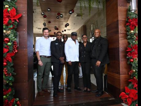 Tourism Minister Edmund Bartlett (centre) is flkanked by (from left) senior executives of the S Hotel Montego Bay, Radu Mot, Romie Morris, Ann-Marie Goffe-Pryce and Andres Cope. In the back is Christopher Jarrett, president of the Jamaica Hotel and Tourist