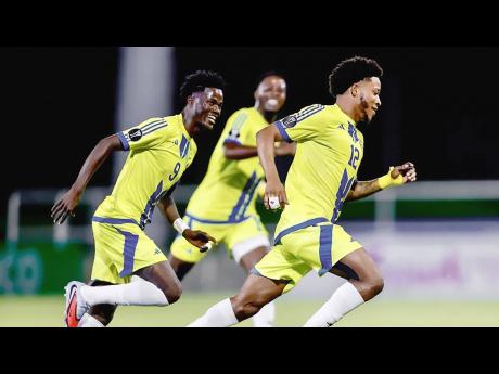 Credit: Courtesy of concacaf.com Mount Pleasant’s Daniel Green (left) goes in chase of Kimoni Bailey (right) as the latter celebrates scoring the lone goal during the first leg of the Concacaf Caribbean Cup final against Universidad O&M at the Estadio Cibao FC in Santiago de los Caballe