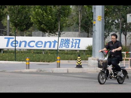 Credit: AP
In this August 7, 2020 photo, a man rides past Tencent headquarters in Beijing, China, on August 7, 2020.