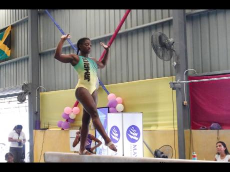 Credit: Contributed Alana Walker balances well on the beam as she competes in the recent Mayberry Investments Gymnastics Championships at the Jamaica College Auditorium.