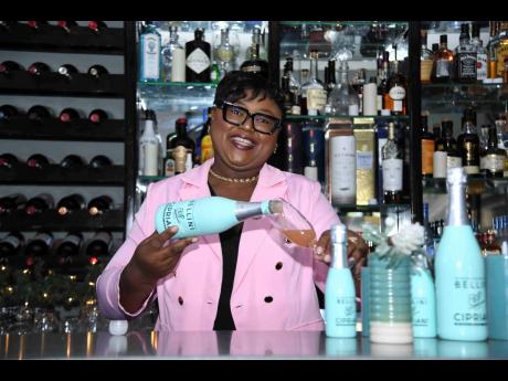 Dr Debbian Spence-Minott, commercial brand manager for wine and spirits at GraceKennedy Limited, pours a glass of Cipriani. 

