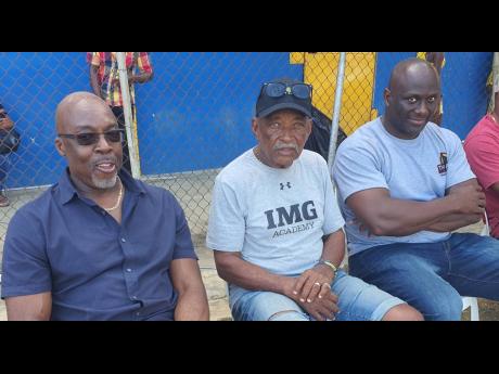 Veteran coach Mike Olivierre (centre) is flanked by Latonel Willams (right), his 1994 Boys Championships Class One 200m/400m runner and Winthorp Graham, the 1984 Boys’ Championships Class One 400m/400m hurdles open winner as they watch proceedings at the