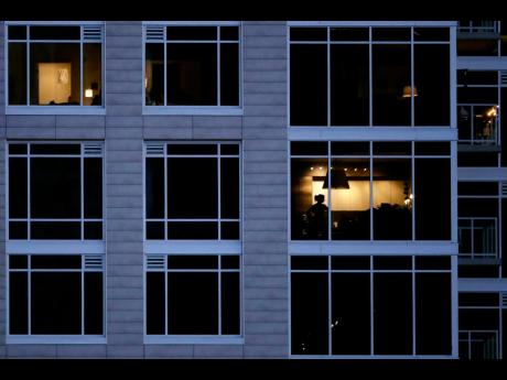 A person looks out of a window in an apartment building in Kansas City, Missouri.