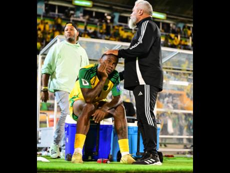 Credit: Gladstone Taylor Craig Butler (right) consoles a dejected Dujuan Richards moments after a 0-0 draw against Curacao at the National Stadium on November 18, 2025 left the Reggae Boyz short of automatic qualification to the FIFA World Cup.