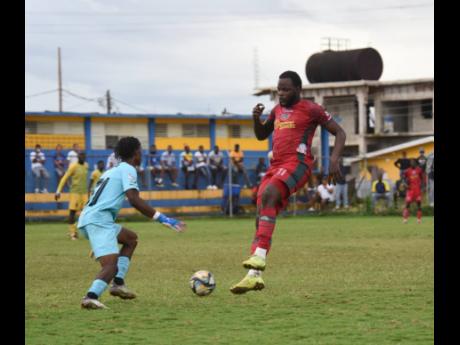 Montego Bay United’s Jourdain Fletcher (right) is challenged by Treasure Beach F.C’s goalkeeper Mowey Morgan (left) during their Jamaica Premier League game at St. Elizabeth Technical High (STETHS) Sports Complex on Sunday, January 4, 2026.