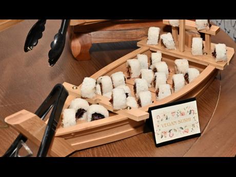 The vegan sushi is a selection of fresh vegetables assembled into neatly rolled sushi, highlighting texture and freshness.  