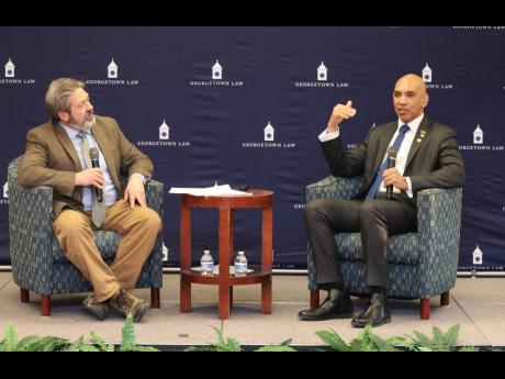 Jamaica’s Ambassador to the United States (US) Major General (Ret’d) Antony Anderson (right), discusses Jamaica’s role in regional security and US-Jamaica co-operation during a public forum organised by the George Town University Law faculty with mod