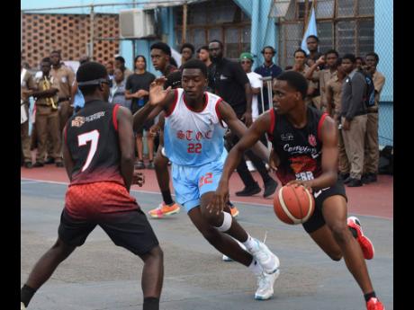 Campion College’s Zachary Lawrence-Smith (right) dribbles by St George’s College’s Imani Salmon (centre), while his teammate Dylon Kelly sets a pick during game two of the ISSA Urban Under-19 Schoolboy Basketball final at St George’s College yester