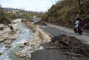 A collapsed section of roadway to Beeston Spring, Westmoreland.