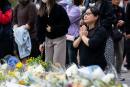 Credit: AP People offer flowers and pray for the victims near the site of a deadly fire at Wang Fuk Court, a residential estate in the Tai Po district of Hong Kong’s New Territories.